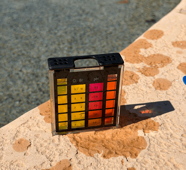 Pool water test kit showing chlorine and pH color chart