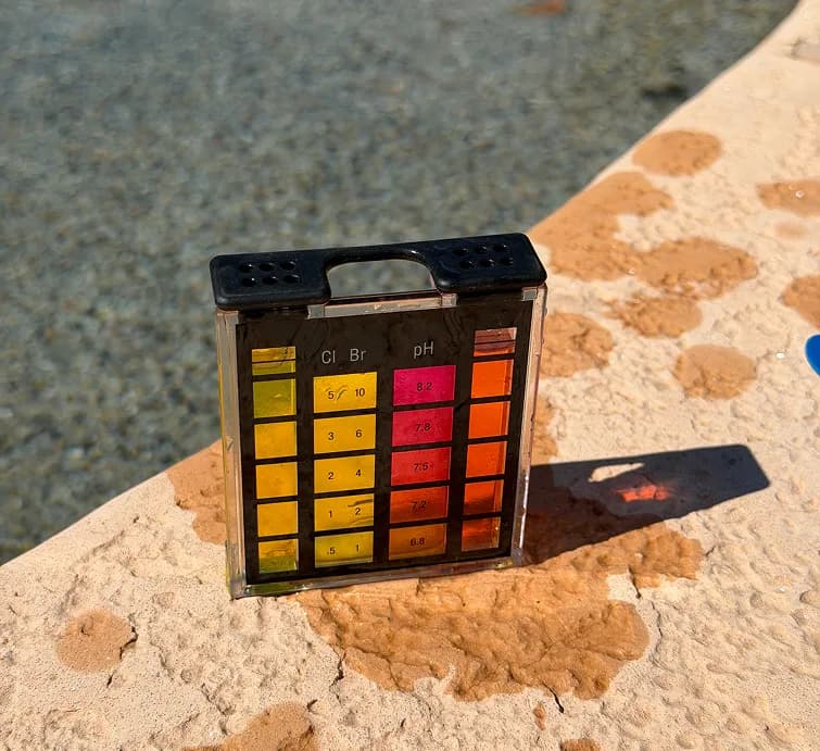 Pool water test kit showing chlorine and pH color chart