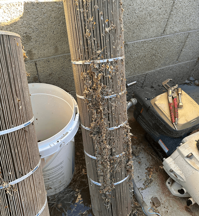 Clogged pool cartridge filter removed for service