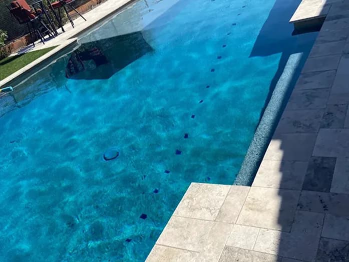 Small backyard pool with bench and privacy wall