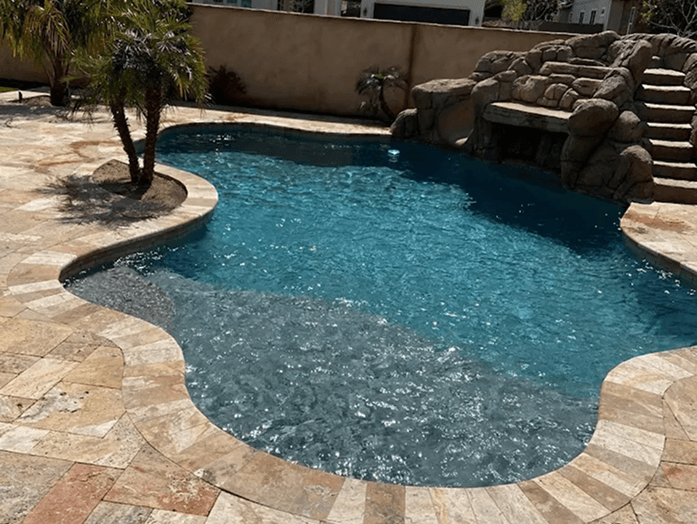 Clear pool water with desert landscaping and patio seating